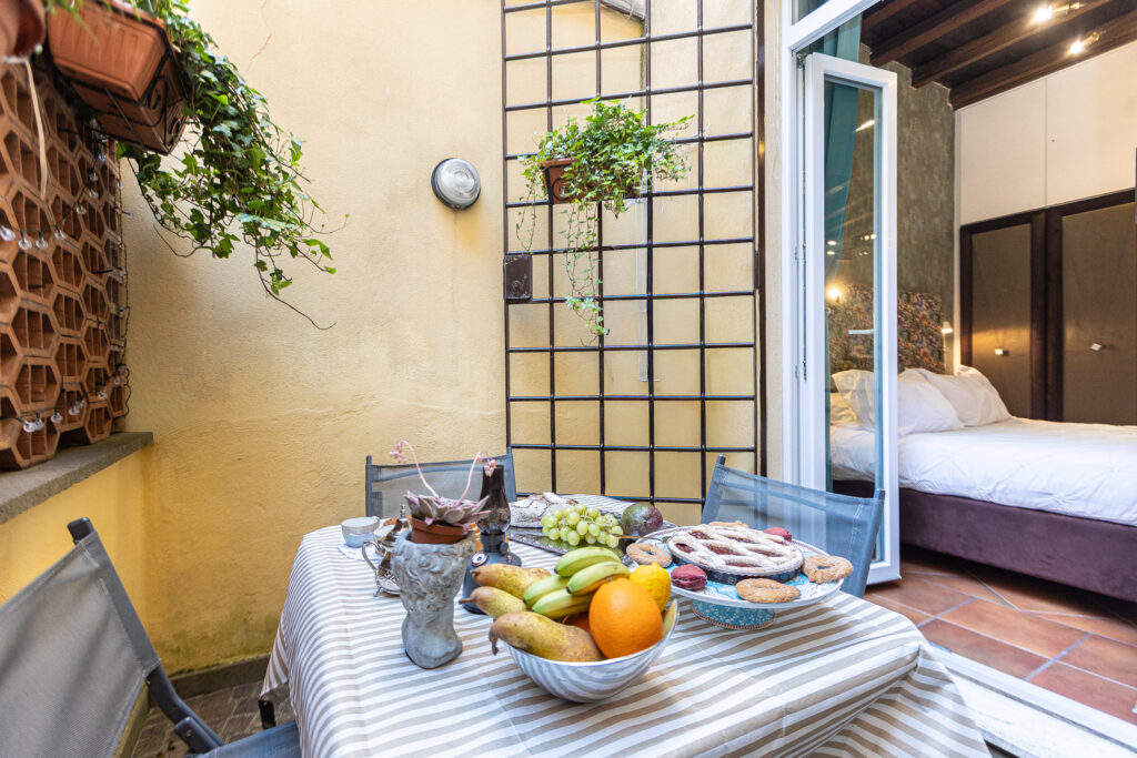 Private patio with an outdoor dining table beside the bedroom