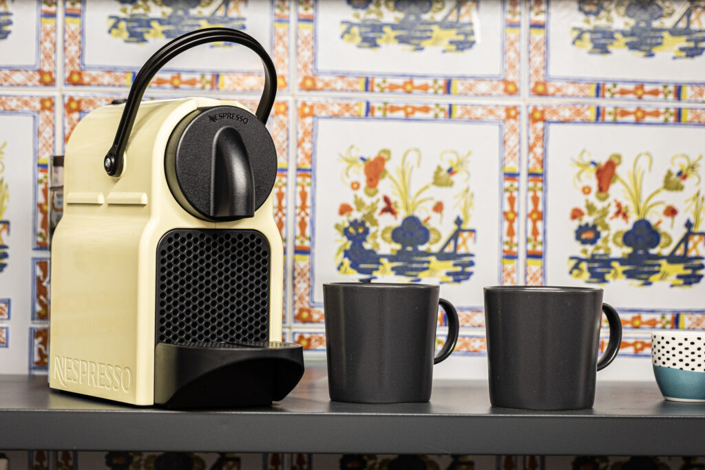 Nespresso coffee machine and cups on the kitchen worktop