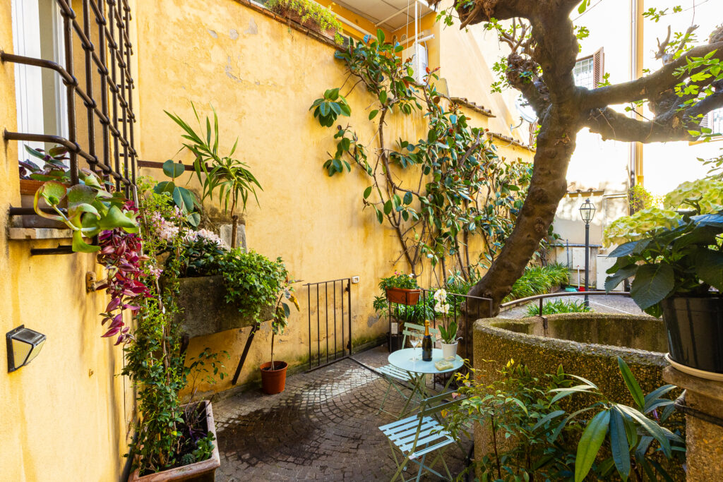 Outdoor seating beside plants overlooking the courtyard