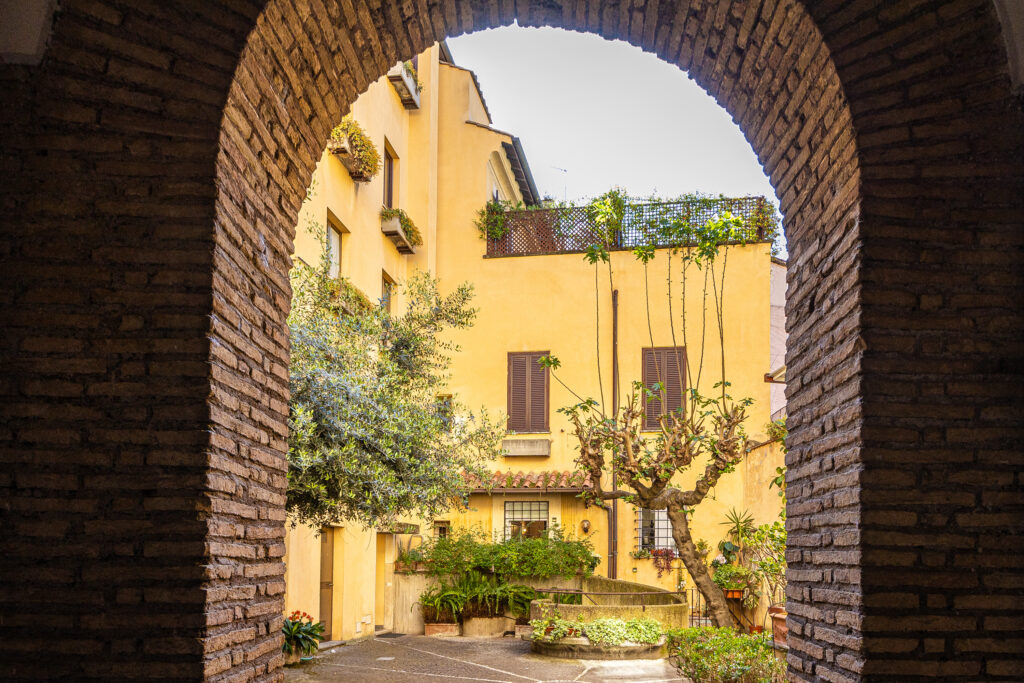 Brick entrance arch framing the palazzo courtyard